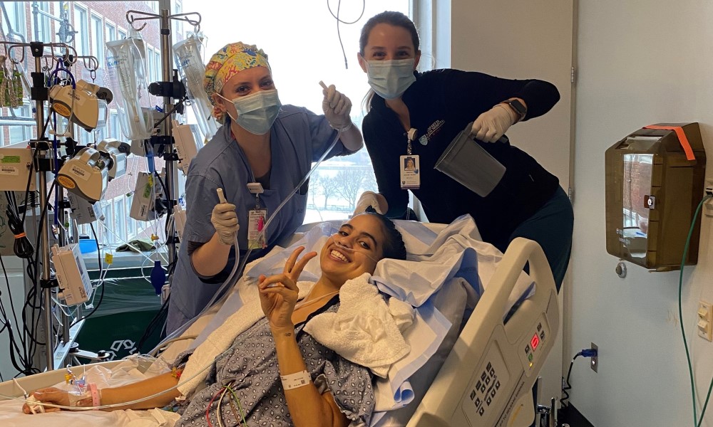 A smiling Ella in the hospital with her nurses.
